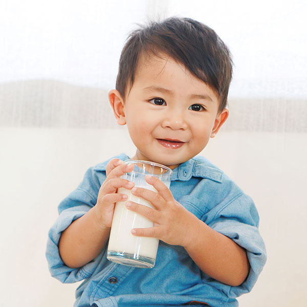 Child Drinking a Glass of Milk